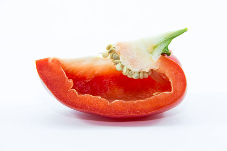 Fresh red bell chili sliced on white backgroundの写真素材