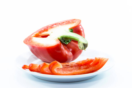 Fresh red bell chili sliced and raw material on white backgroundの写真素材