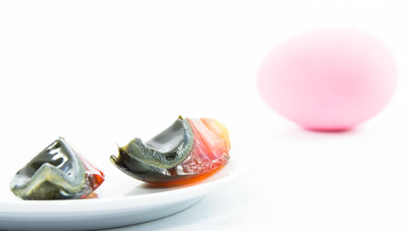 Duck's egg preserved sliced with blurring raw material on white backgroundの写真素材