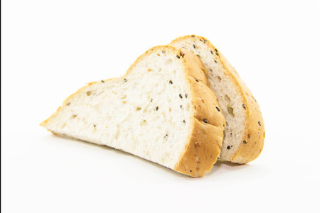 Cutting whole grain bread for breakfast on white backgroundの写真素材