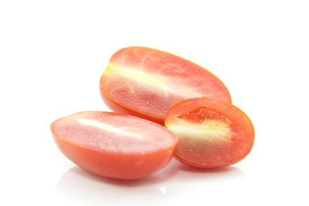 Mini tomato cross section sliced on white backgroundの写真素材