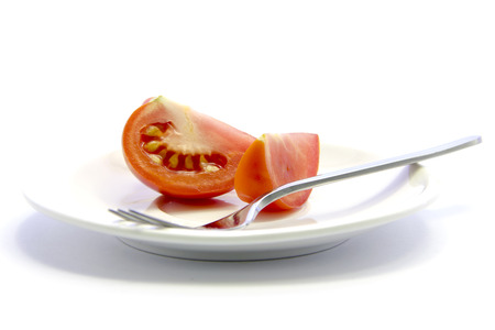Tomatoes quarter sliced texture recipe healthy meal on white backgroundの写真素材