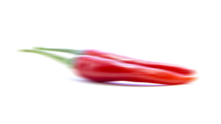 Blurring red chili pepper couple on white backgroundの写真素材