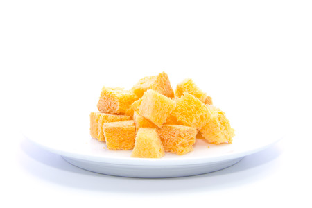 Carrot orange color bread dice cut on white plate and white backgroundの写真素材