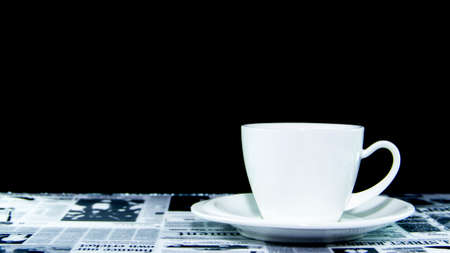 White cup of coffee pure ceramic on table mat and black backgroundの写真素材
