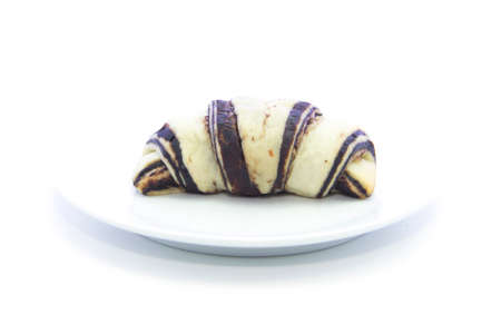 Croissant texture with chocolate on white plate and white backgroundの写真素材