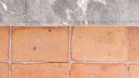 Clay tile and polished stone material pattern on pavement