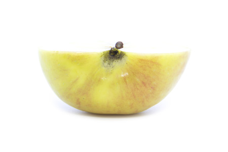 Half yellow apple cross section sliced on white backgroundの写真素材