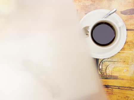 Foggy blurring with cup of coffee on vintage table setの写真素材