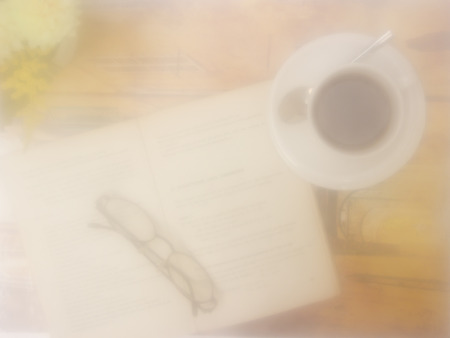 Blurring Book with cup of coffee on vintage backgroundの写真素材