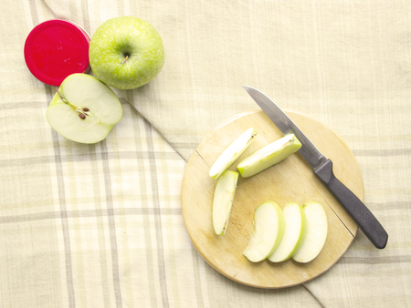 Green Apple sliced ingredient on chopping board and table mat backgroundの写真素材