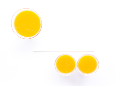 Baby carrots fresh juice glass on white backgroundの写真素材