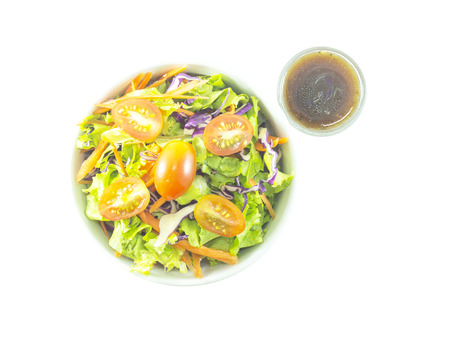 Mixed salad with balsamic dressing shot on white backgroundの写真素材