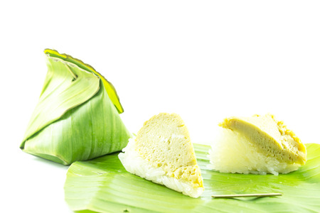 Sticky rice custard in banana leaf packaging on white backgroundの写真素材