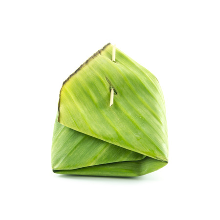 Green packaging with banana leaf side view on white backgroundの写真素材