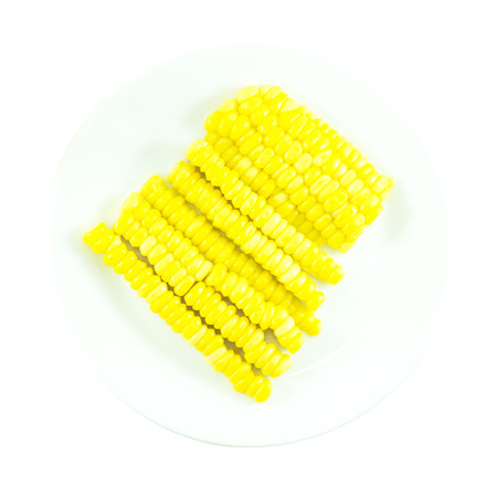 Sweet yellow corn slice ingredient on white plateの写真素材