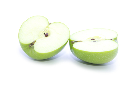 Organic green apple half sliced on white backgroundの写真素材