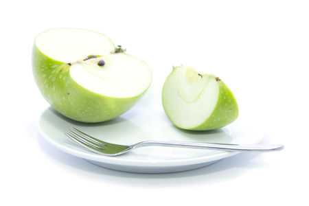 Fresh sliced green apple diet food on white plate and white backgroundの写真素材