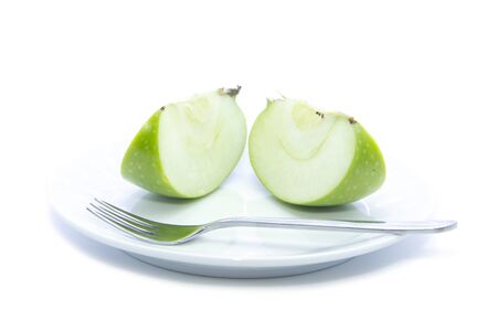 Quarter sliced green apple diet food on white plate and white backgroundの写真素材