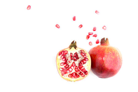 Seed and half pomegranate section and skin top view on white backgroundの写真素材