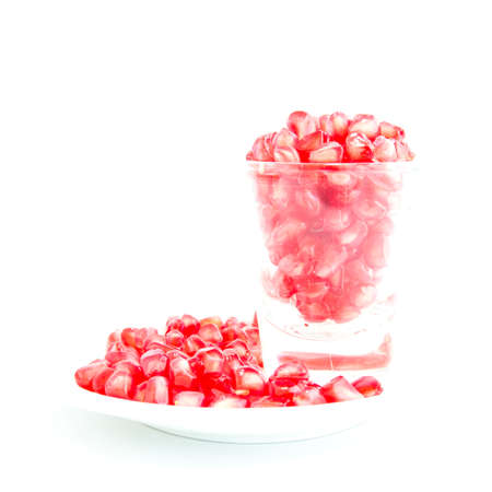 Nutrition Pomegranate serve in glass shot on white plate and  white backgroundの写真素材