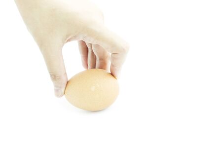 Give Fresh egg from organic farm with hand on white backgroundの写真素材