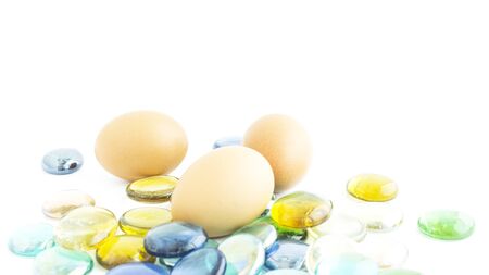 Eggs set on artificial colorful rock and white backgroundの写真素材
