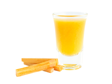 Carrots juice shot glass with raw material on white backgroundの写真素材