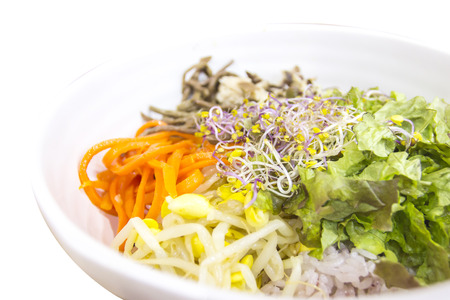Bibimbab rice mixed with vegetable in Korean style on white backgroundの写真素材