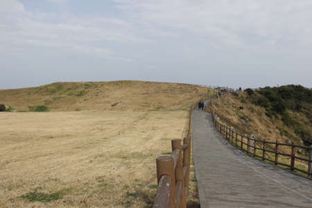 Brown hill with walk way in winter on blue sky backgroundの写真素材