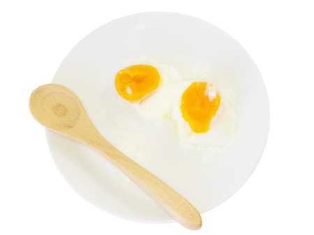 Smooth boiled egg yolk on white plate and white backgroundの写真素材