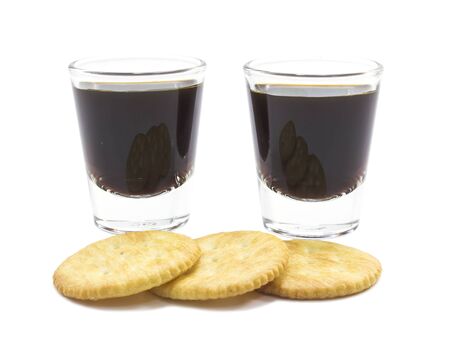 Coffee espresso shot and cracker on white background