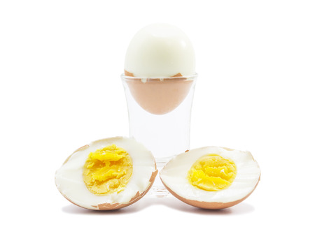 Boiled egg half cut with peel eggshell on white backgroundの写真素材