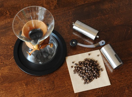 Coffee beans and grinder on a wooden backgroundの写真素材