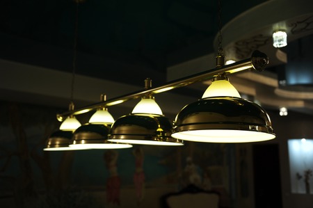 Lamps on the pool table. Lighting in the darkの写真素材