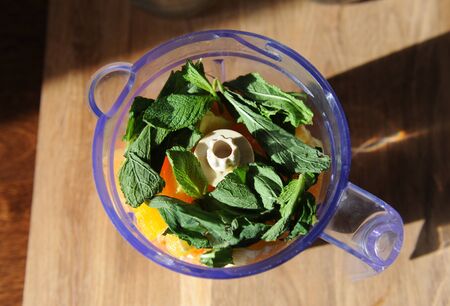 Fruits and vegetables in blender. Preparation of a healthy smoothie