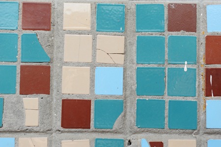 Texture of small square tiles. Beige, blue, turquoise and brown colors