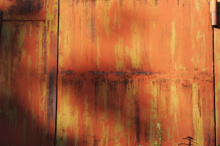 Texture of old shabby metal surface. Cracks, scrapes and bright spots of colored paintの写真素材