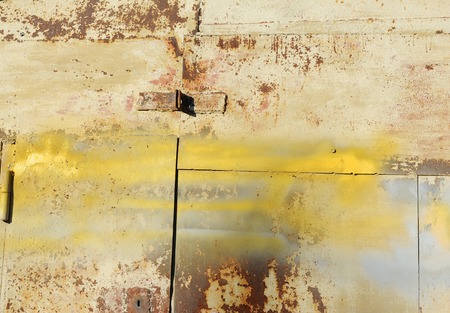 Texture of old shabby metal surface. Cracks, scrapes and bright spots of colored paintの写真素材