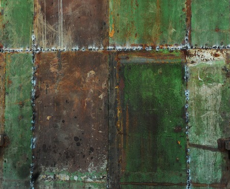 Texture of old shabby metal surface. Cracks, scrapes and bright spots of colored paintの写真素材