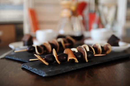 Skewers with mini pancakes and grapes on slate plates. Coffee in the filter in the background. Breakfastの写真素材