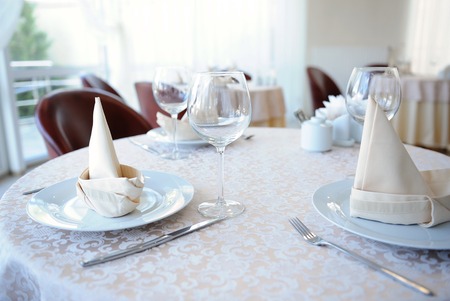 Served table in restaurant for three personsの写真素材