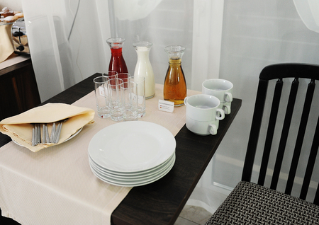 Buffet table with drinks in a hotel. Morse, milk and juice in decantersの写真素材