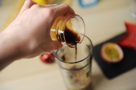 Making a coffee cocktail. Pouring espresso shot into a shaker.の写真素材