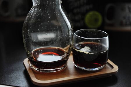 Stylish served specialty alternative black coffee. Bamboo tray, carafe decanter and glass....
