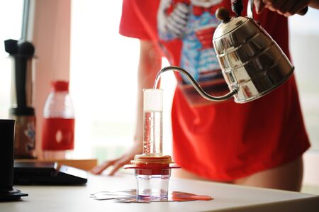 Home brewing coffee in a compact manual espresso makerの写真素材