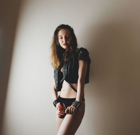 Beautiful sexy girl in black with red manual coffee grinderの写真素材