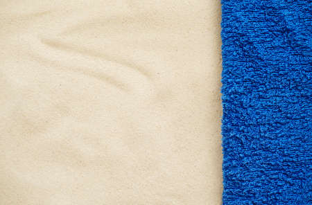 Beach resort theme background, texture. Blue towel on the sand. Space for designの写真素材