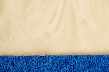 Beach resort theme background, texture. Blue towel on the sand. Space for designの写真素材