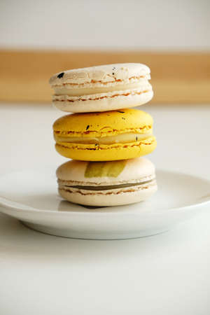 Macaroons on white plate. French cuisine dessert, gentle colors